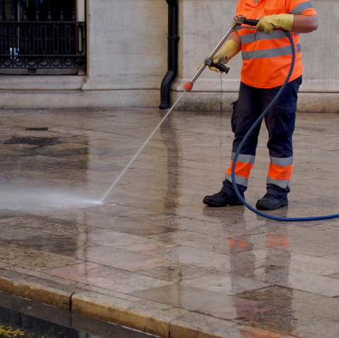 man cleaning a concrete commercial flooring